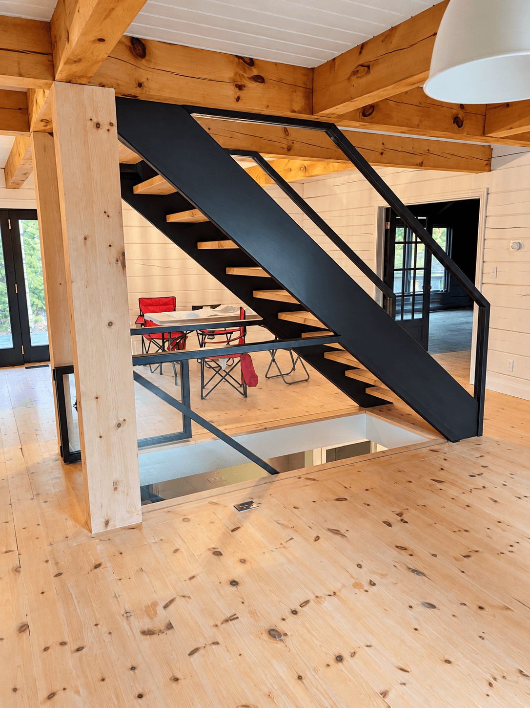 Dark stair structure against a warm wood interior