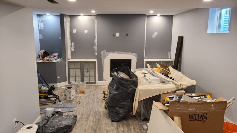 Wall patches and tools around a fireplace during interior repairs